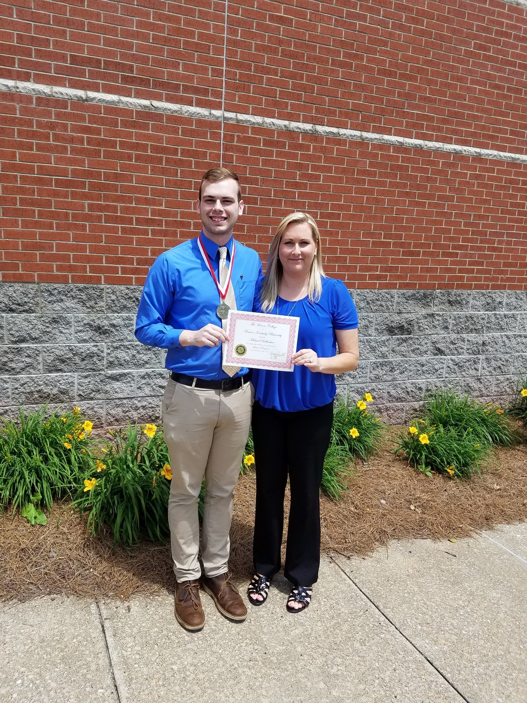 Drake Stapleton and his mother celebrating graduation together in May 2016