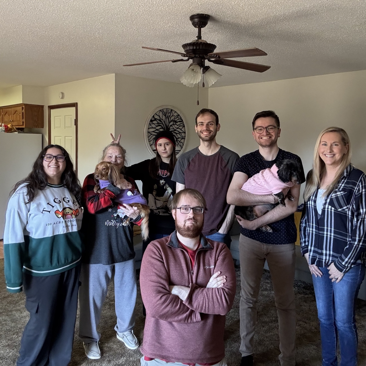 Family group photo: Victoria, Granny holding Ruby the dachshund, Summer, Drake Stapleton, Devin, and their mother, with his brother kneeling front and center
